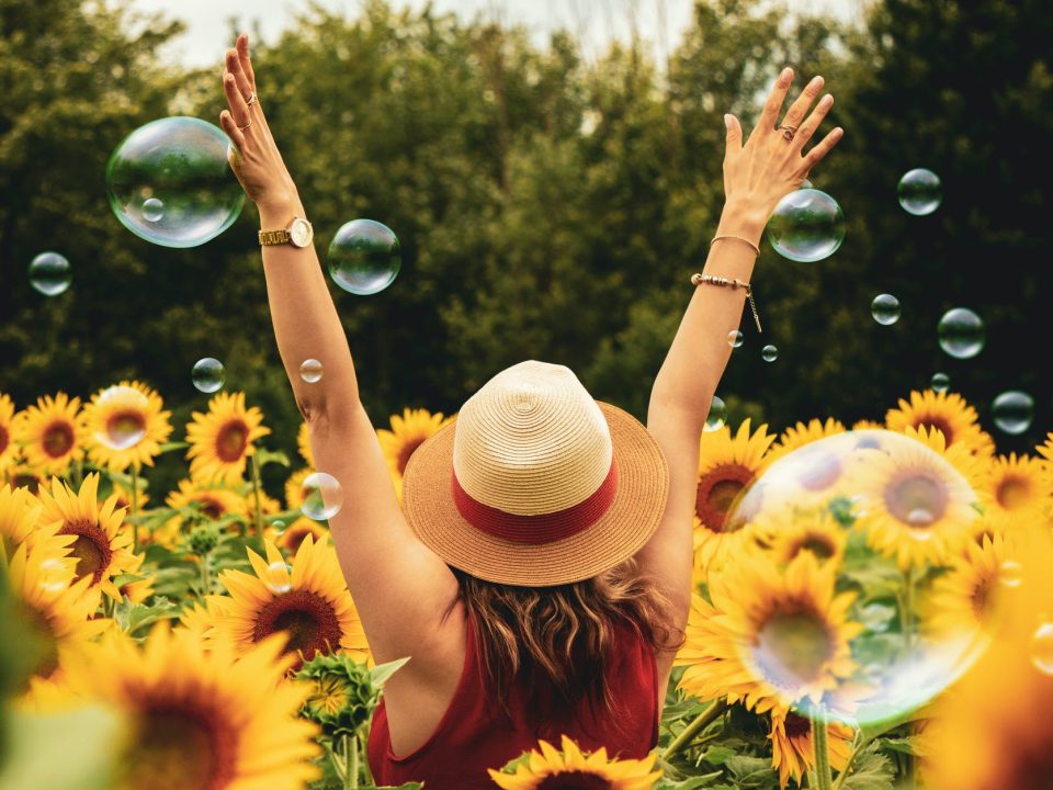 woman surrounded by sunflowers